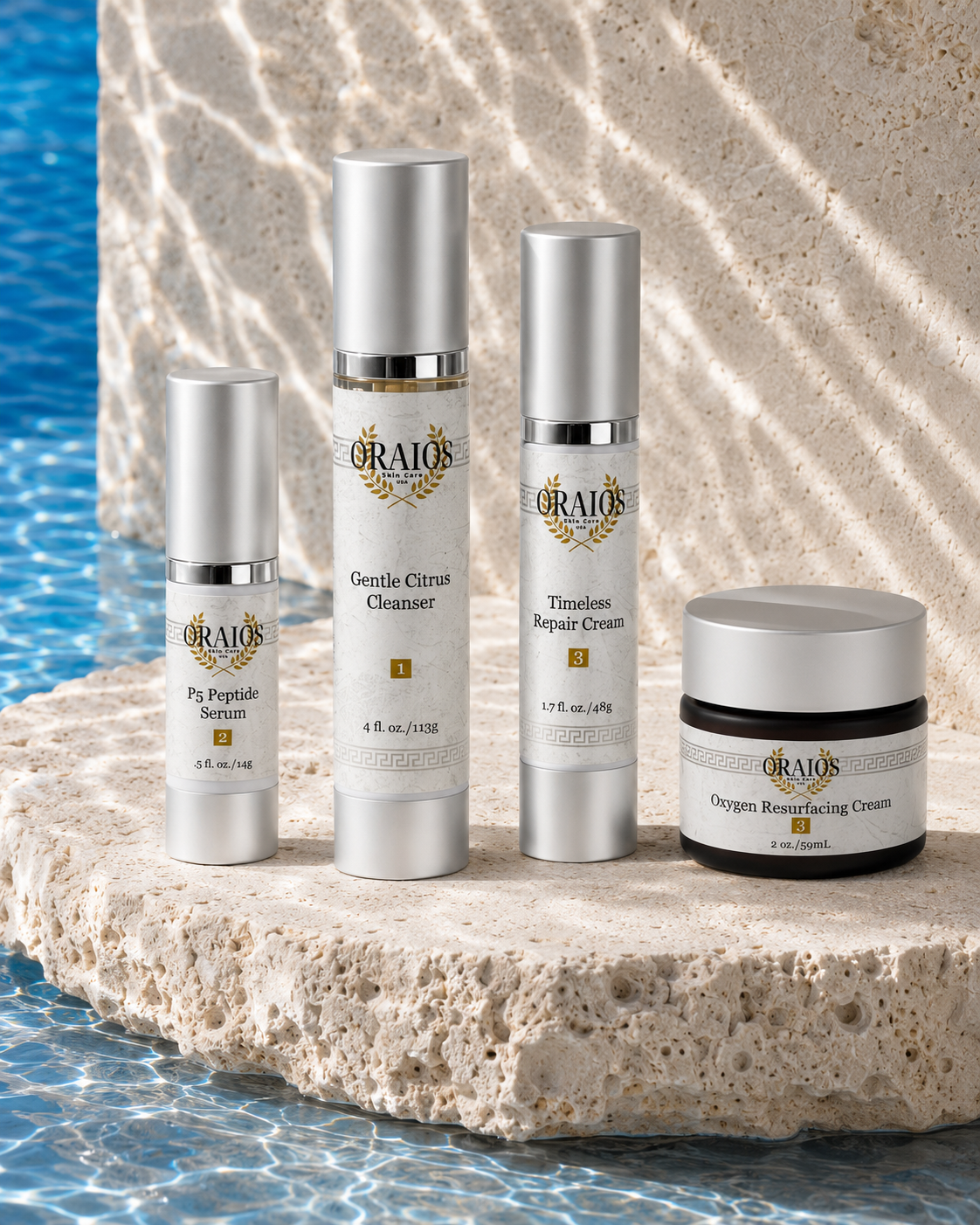 Oraios skincare products arranged beside Aegean-blue water
